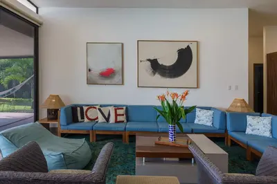 a living room with a blue couch and a table at Ayanna Beach Front in La Libertad