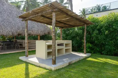 a wooden shelter on the grass in a yard at Ayanna Beach Front in La Libertad