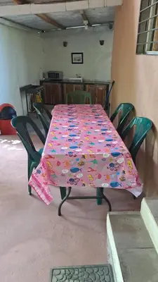a table with a flowered table cloth on it at Casita Escondida- El Salvador in La Libertad