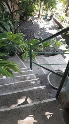 a set of concrete stairs with a hose on it at Casita Escondida- El Salvador in La Libertad