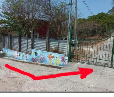 a red line on the ground next to a fence at Casita Escondida- El Salvador in La Libertad