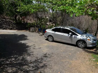 a silver car parked on the side of a road at Casita Escondida- El Salvador in La Libertad
