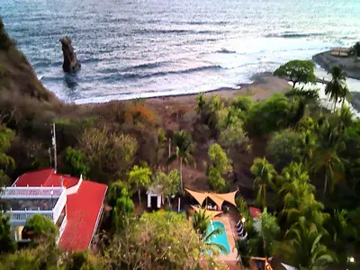 a view of a beach with a house and the ocean at Jaco Mizata Beach and River in La Libertad