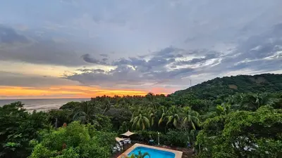 a view of the ocean from a resort with a swimming pool at Jaco Mizata Beach and River in La Libertad