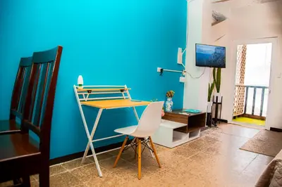 a blue room with a desk and a chair at Sunset View - Mini Loft in La Libertad