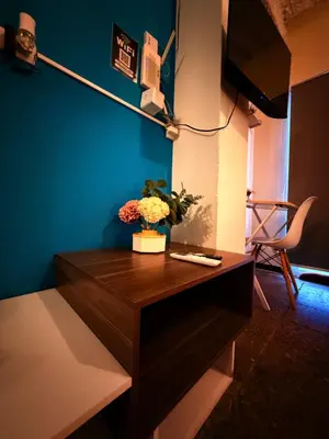 a desk with a vase of flowers on top of it at Sunset View - Mini Loft in La Libertad