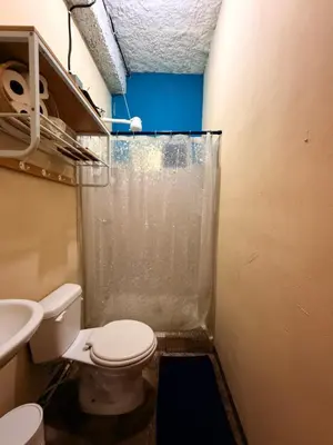 a small bathroom with a toilet and a sink at Sunset View - Mini Loft in La Libertad