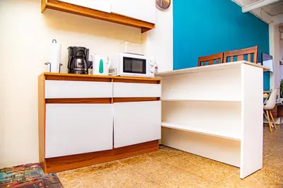 a kitchen with white cabinets and a microwave at Sunset Views - Acogedor con vista al mar in La Libertad
