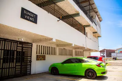 a green car parked in front of a building at Sunset Views - Acogedor con vista al mar in La Libertad