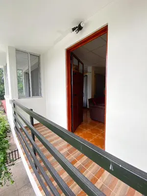 an open door of a house with a porch at MARIA III HOSTAL in Juayúa
