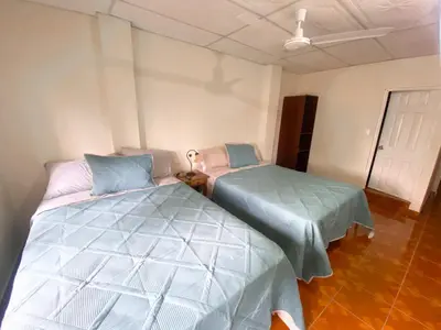 a bedroom with two beds in a room at MARIA III HOSTAL in Juayúa
