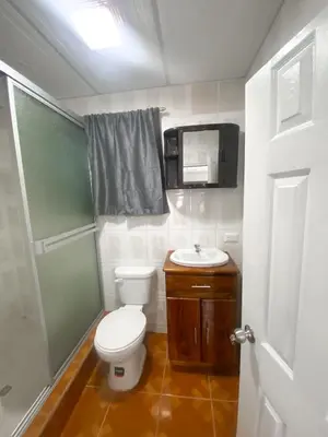 a small bathroom with a toilet and a sink at MARIA III HOSTAL in Juayúa