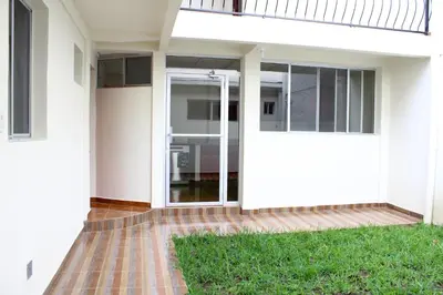 an open door of a house with a lawn at MARIA III HOSTAL in Juayúa