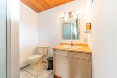 a bathroom with a toilet and a sink at Volcano Hostal y Restaurante in San Salvador