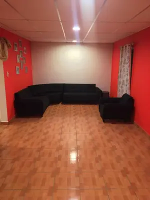 a living room with black couches and red walls at Casa Topacio 1 in Santa Ana