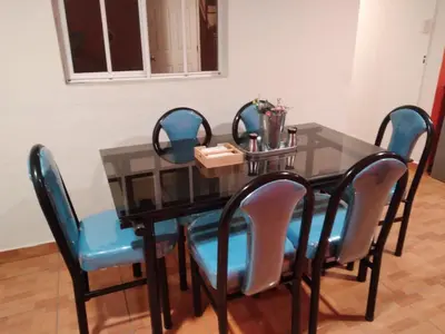 a dining room table with four chairs and a glass table at Casa Topacio 1 in Santa Ana
