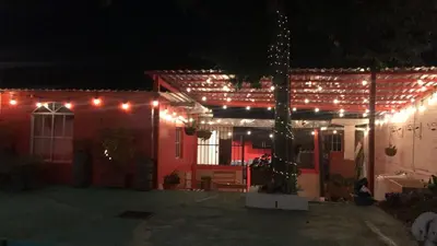 a red house with lights on it at night at Casa Topacio 1 in Santa Ana