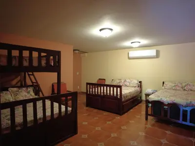 a room with two cribs and a bunk bed at El Castillo de Piedra in San Miguel