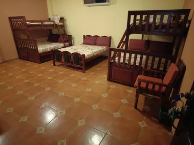 a room with two bunk beds and a tiled floor at El Castillo de Piedra in San Miguel