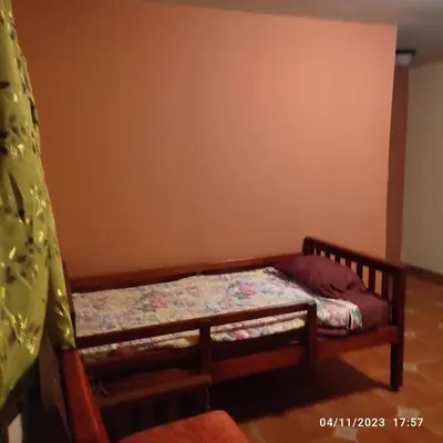 a small bedroom with a bed in the corner at El Castillo de Piedra in San Miguel