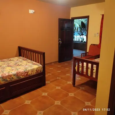 a bedroom with two beds and a tv on the wall at El Castillo de Piedra in San Miguel