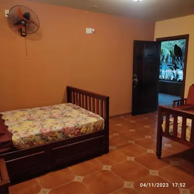 a bedroom with a bed and a tv on the wall at El Castillo de Piedra in San Miguel