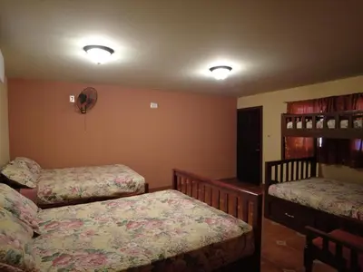 a bedroom with two twin beds and a shelf at El Castillo de Piedra in San Miguel