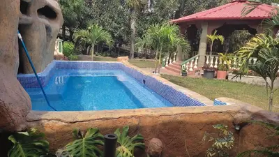 a swimming pool in front of a house at El Castillo de Piedra in San Miguel