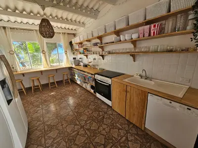 a kitchen with a sink and a stove top oven at Sunset Surf Villa in La Libertad