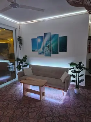 a living room with a couch and a coffee table at Sunset Surf Villa in La Libertad