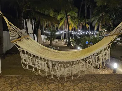a hammock in a resort at night with lights at Sunset Surf Villa in La Libertad
