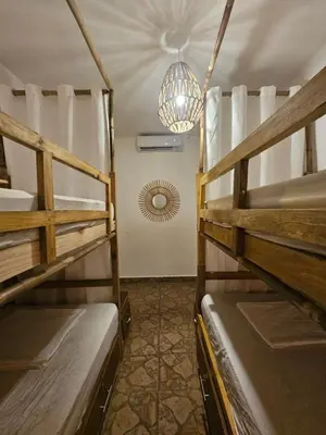 a room with two bunk beds and a chandelier at Sunset Surf Villa in La Libertad