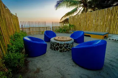 a group of blue chairs and a table on the beach at Ocean Paradise in Barra de Santiago