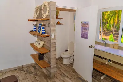 a bathroom with a toilet and a sink at Ocean Paradise in Barra de Santiago