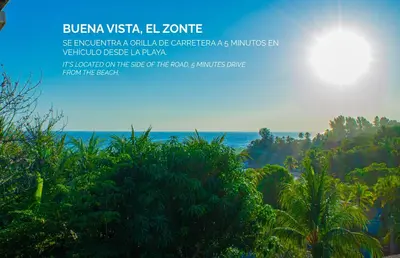 a view of the ocean from a hill with trees at Buena Vista El Zonte in El Zonte