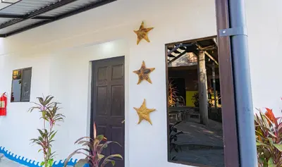 two stars on a wall next to a door at Buena Vista El Zonte in El Zonte