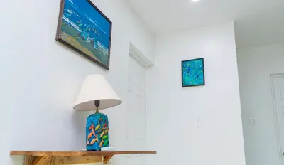 a lamp on a table next to a wall at Buena Vista El Zonte in El Zonte