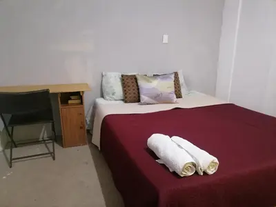 a bedroom with a bed with towels on it at costa azul apartment el zonte in La Libertad