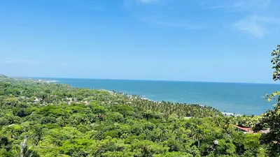 a view of a hill with the ocean in the background at Eco Sky Villas in El Sunzal