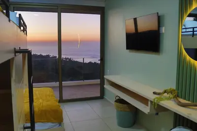 a room with a window with a view of the ocean at Eco Sky Villas in El Sunzal