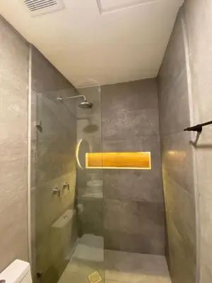 a shower with a glass door in a bathroom at Eco Sky Villas in El Sunzal