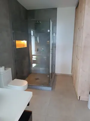 a bathroom with a shower and a toilet at Eco Sky Villas in El Sunzal