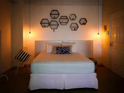 a bedroom with a large bed in a room at Acogedor Loft, Playa Las Flores in La Libertad