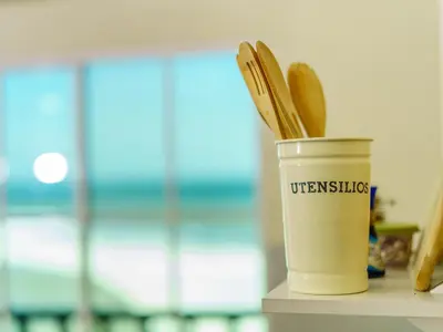 a cup of coffee with wooden utensils in it at Acogedor Loft, Playa Las Flores in La Libertad