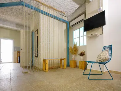 a room with a chair and a table at Acogedor Loft, Playa Las Flores in La Libertad