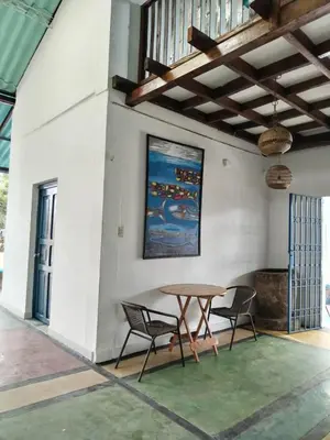 a dining room with a table and two chairs at Chilamar Surf Lodge in La Libertad