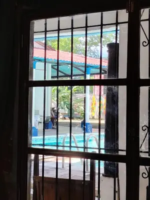 a view of a swimming pool through a window at Chilamar Surf Lodge in La Libertad