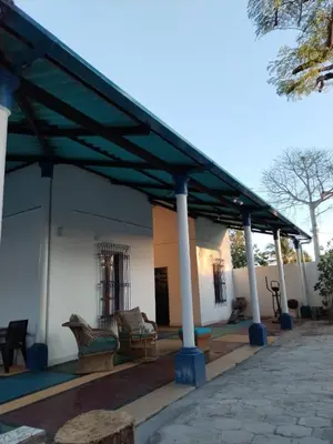 a building with a pavilion with chairs and tables at Chilamar Surf Lodge in La Libertad