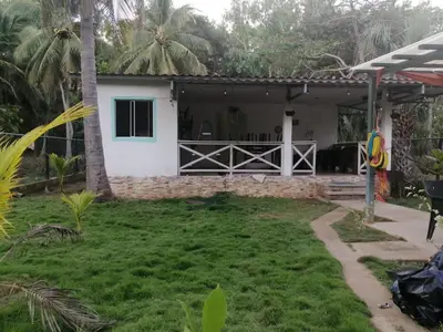 a house with a garden in front of it at Casa Jaragua in Barra de Santiago