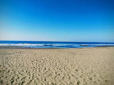 a sandy beach with the ocean in the background at Casa Jaragua in Barra de Santiago